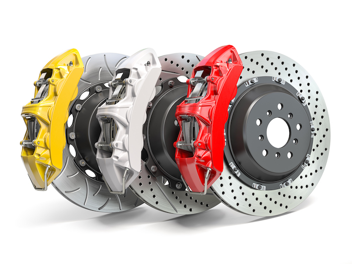 Braking system. Car brake disks with different perforations and calipers  isolated on white background. 3d illustration